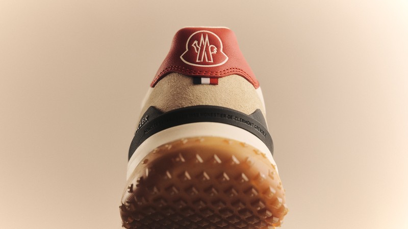 Moncler CityTrek sneaker for Her: white and beige sneakers, white trousers, sweater and bag, brown jacket.