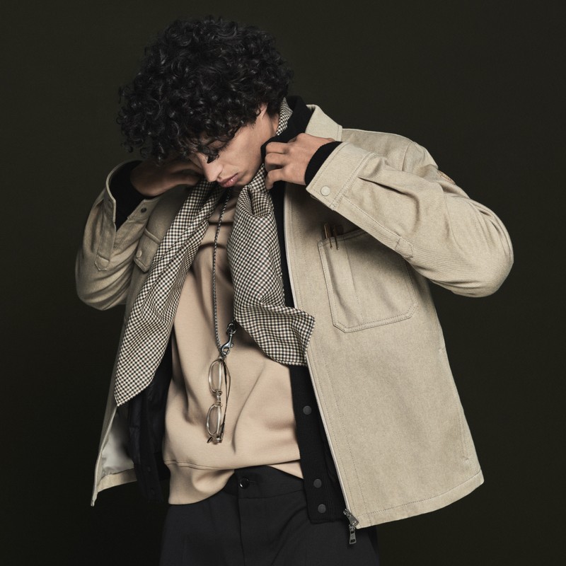 Moncler Fall/Winter 2026 for men: beige sweatshirt, beige jacket layered over a light blue one, and a scarf.