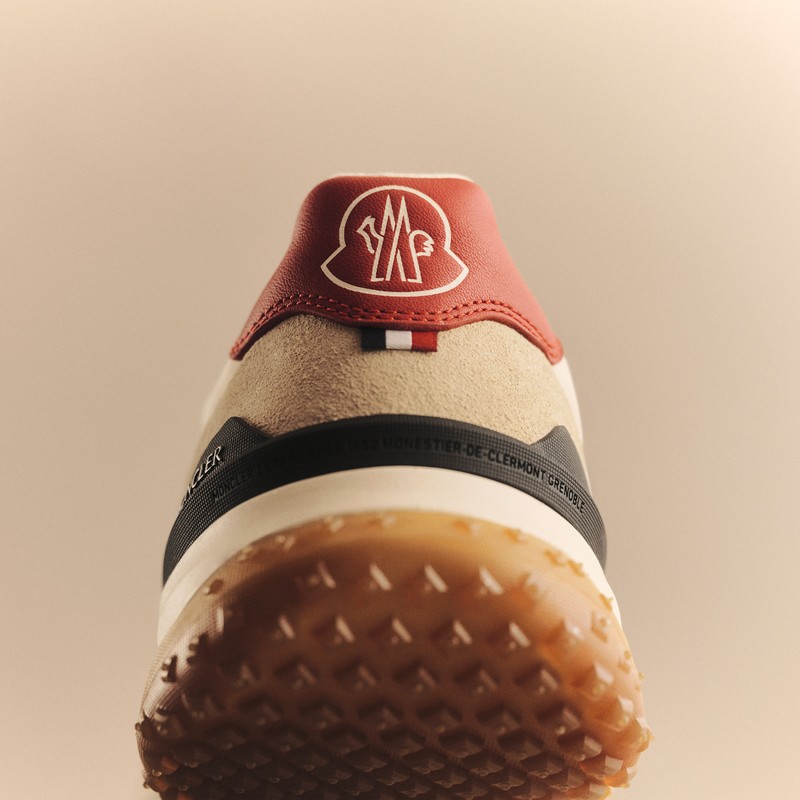 Moncler CityTrek: back of the shoe with black, beige and red details, logo and rubber sole.
