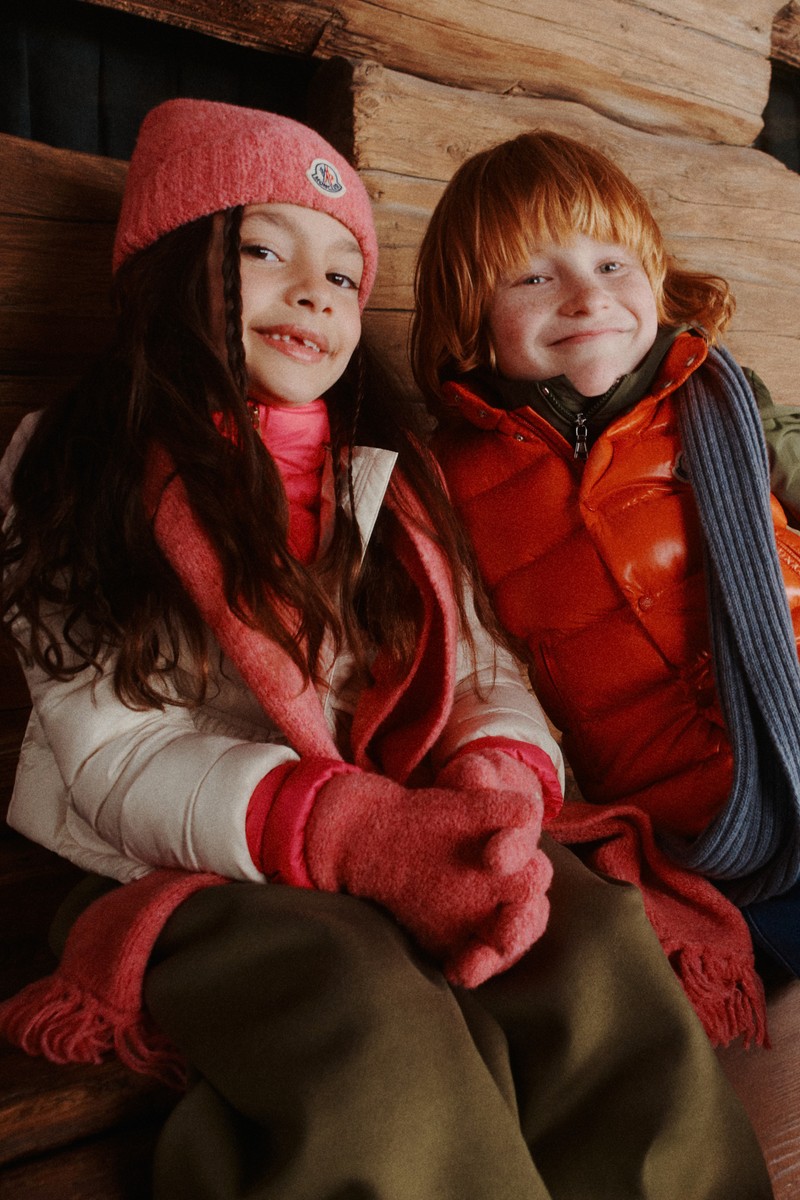 Moncler accessories for girls. Pink beanie, scarf and gloves, orange down vest and grey scarf.