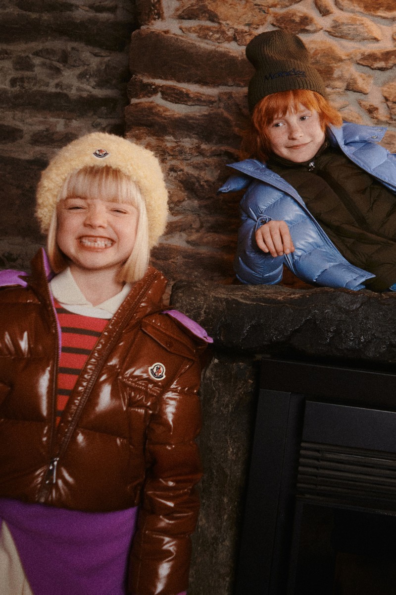Moncler kids: brown down jacket, striped sweater, purple pants, logo beanie; beanie, green sweatshirt, blue down jacket.