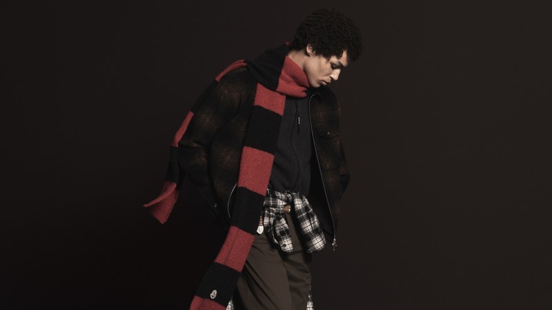 Moncler Fall/Winter 2026, brown checked jacket, red and black striped scarf, checked shirt, black sweatshirt, brown trousers.