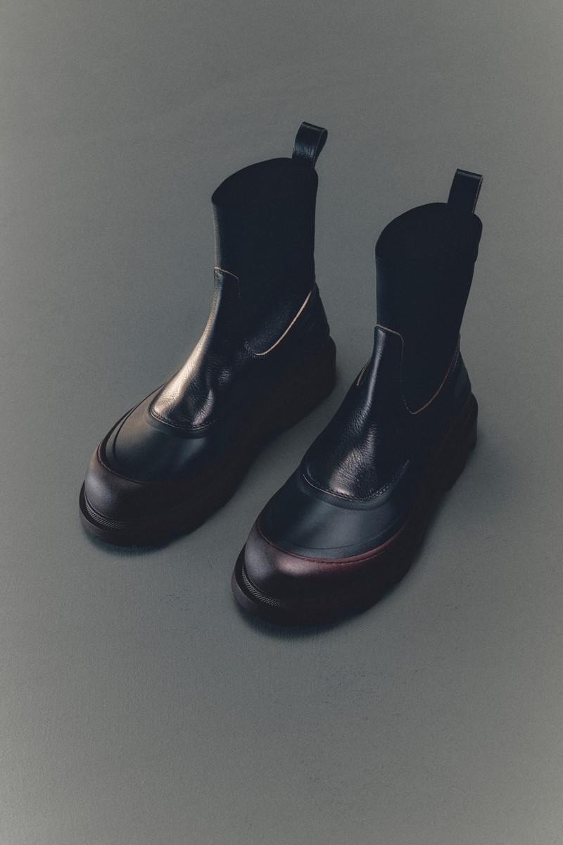 Moncler Footwear: white and beige sneaker with black and red details and rubber sole.