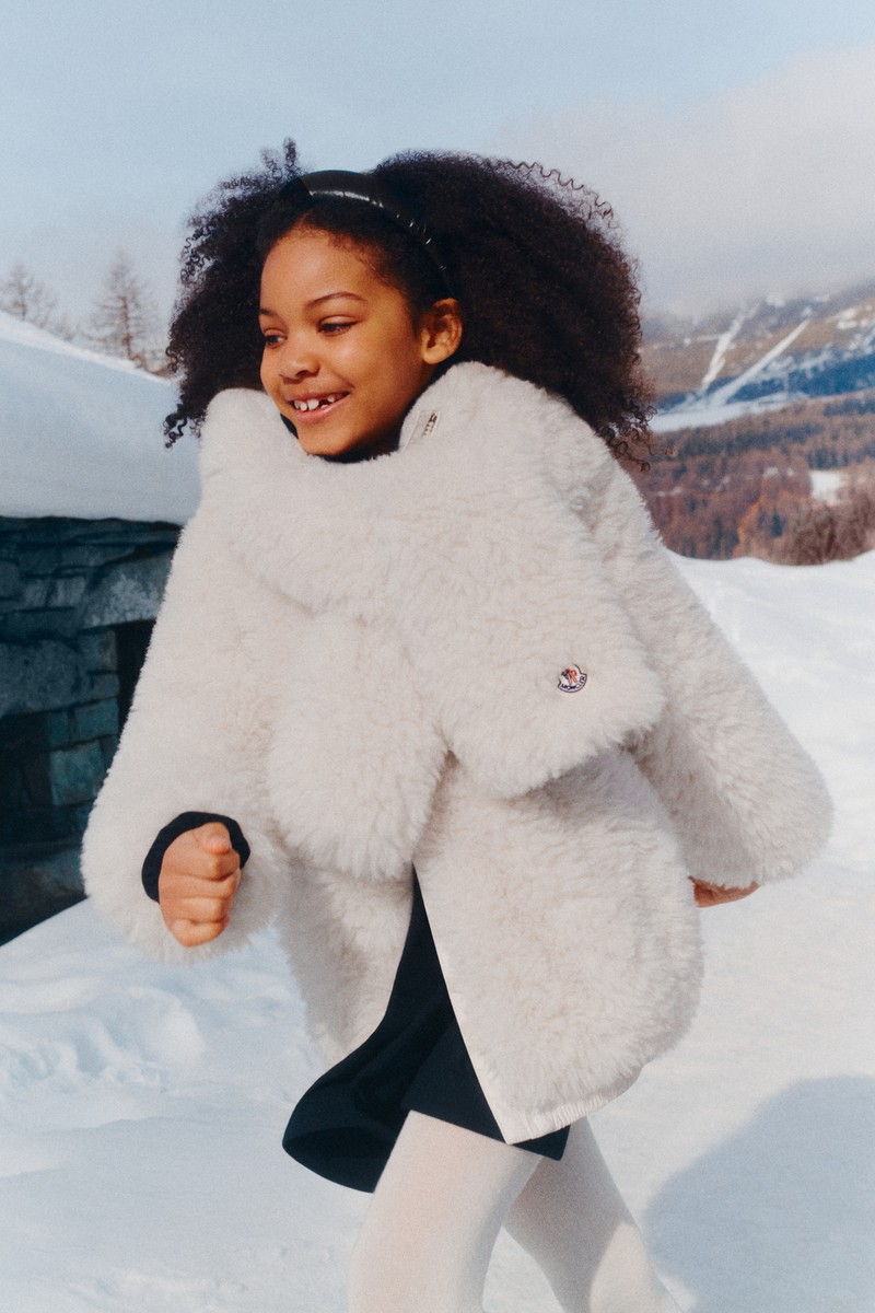 Moncler for Children. Fluffy white coat and scarf, and white boots for girls.