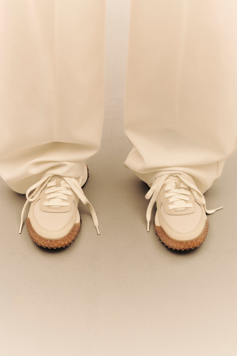 Moncler CityTrek: beige and white sneakers with black and red details, shown from different angles and worn.