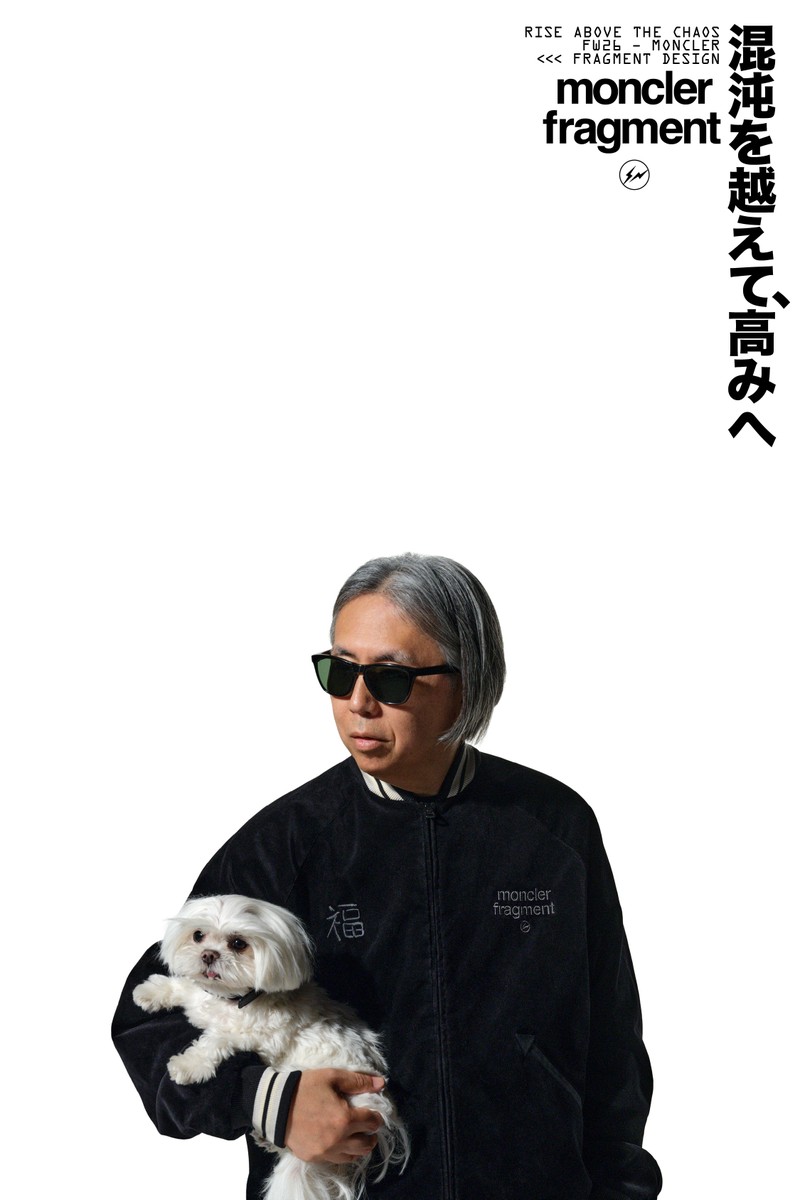 Moncler x Fragment, Hiroshi Fujiwara wearing black jacket with white and black striped details, black sunglasses. 